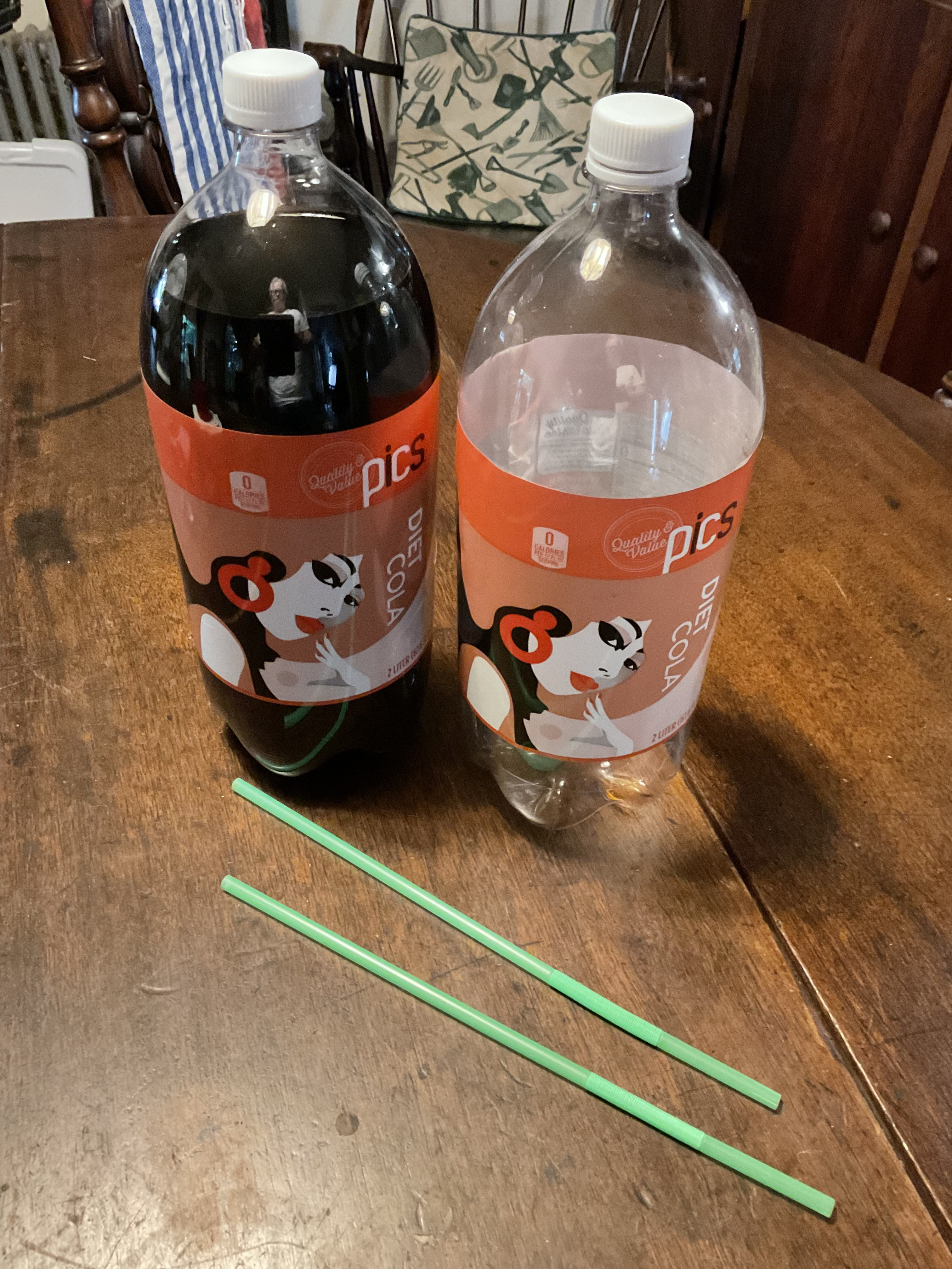 Two soda bottles with straws